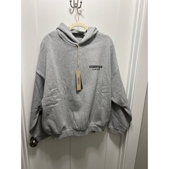 Fear of God Essentials grey colorway with side pockets. No kangaroo pocket